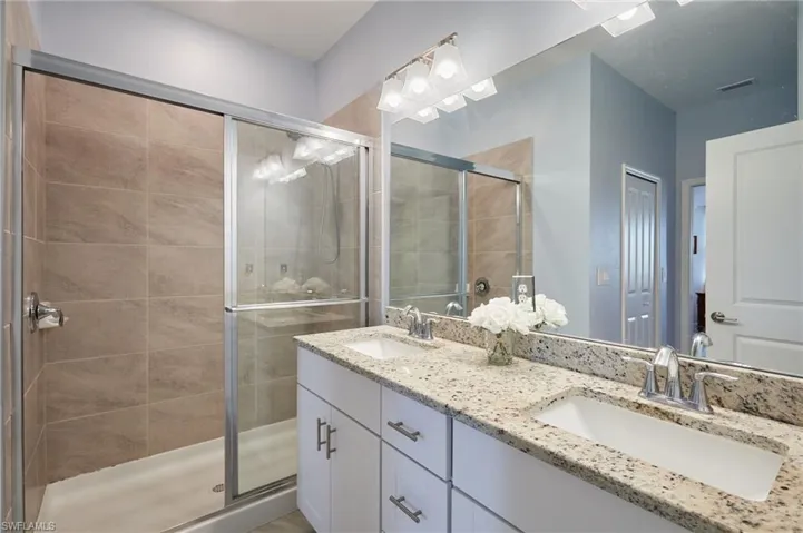 Bathroom with vanity and an enclosed shower