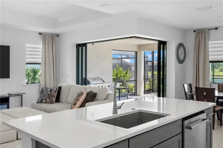Zero corner sliding glass doors allow for a seamless transition from inside to the lanai/pool area.