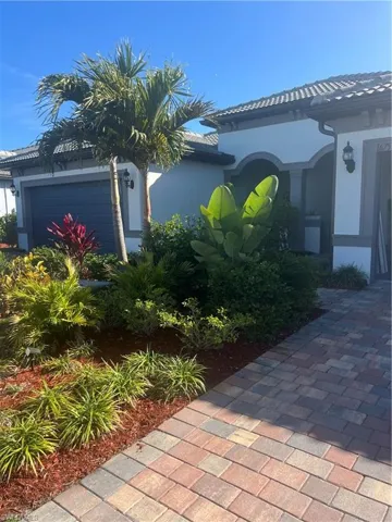 View of side of home featuring stucco siding and an attached garage