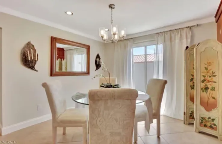 Dining space with light tile patterned floors, a notable chandelier, recessed lighting, and baseboards