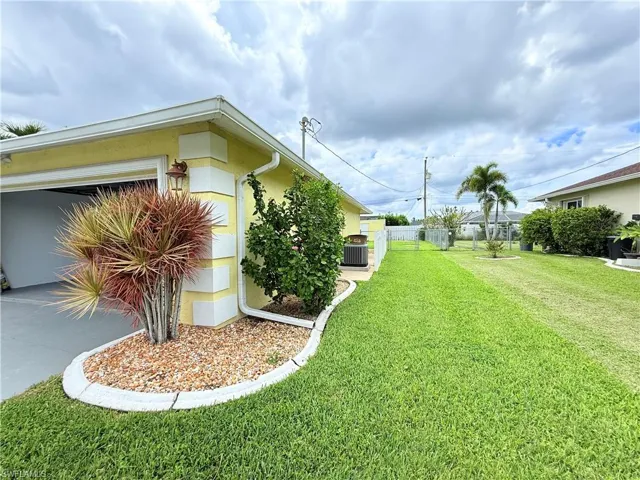 View of yard with concrete driveway and a garage