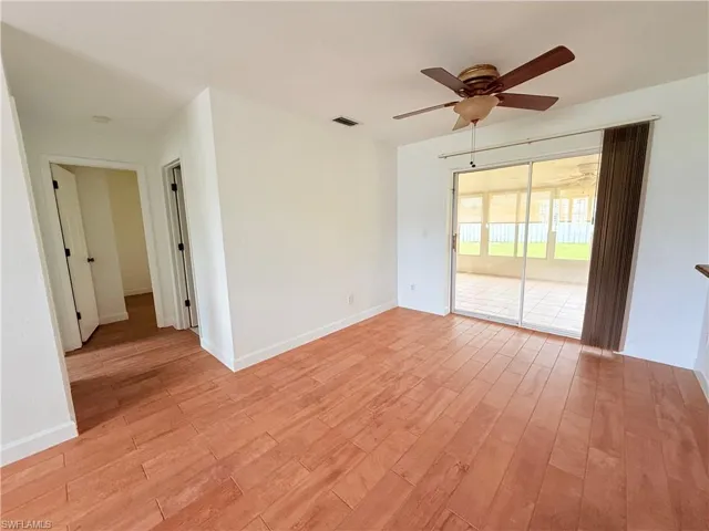 Spare room featuring light wood-type flooring and a ceiling fan