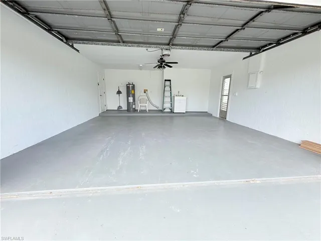 Garage with electric water heater and a textured wall