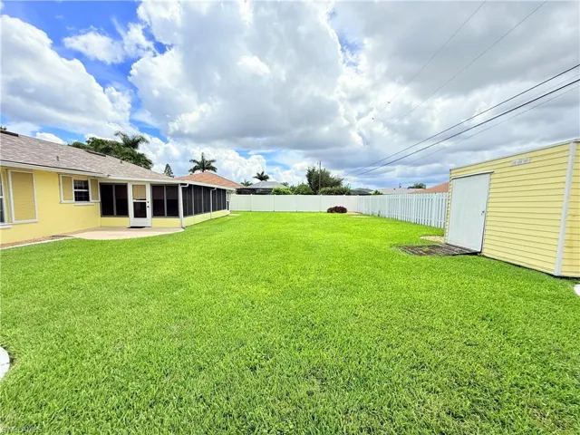 Fenced backyard with a sunroom