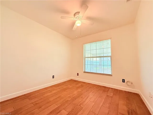 Unfurnished room with light wood-style floors and a ceiling fan