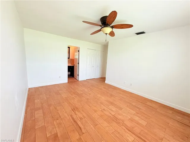 Unfurnished room featuring light wood-type flooring and ceiling fan