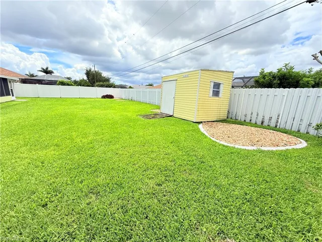 Fenced backyard with a shed