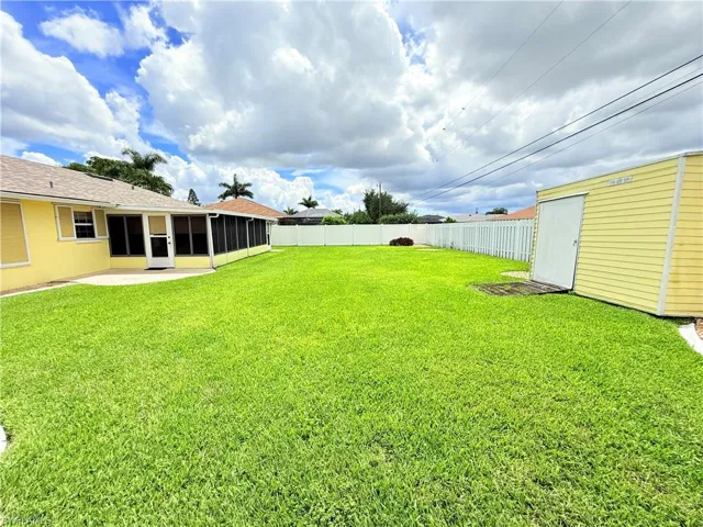 Fenced backyard with a sunroom