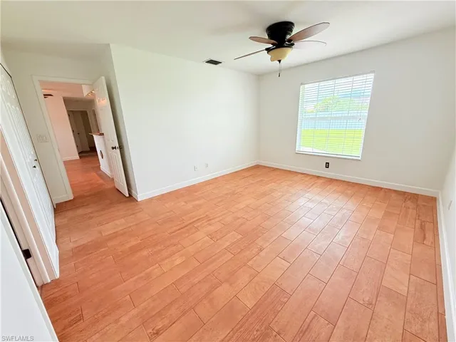 Empty room featuring light wood-style floors and ceiling fan