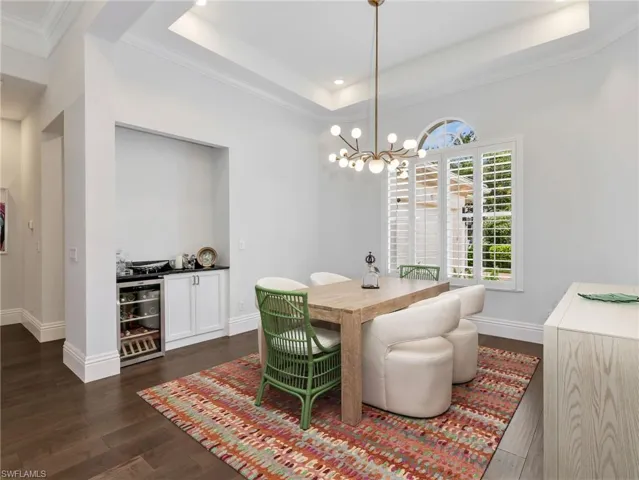 The dining room with new designer lighting , built in beverage cooler and dry bar.