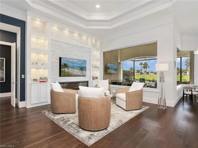 A perfect conversation area with a built in stone bookcase with electric fireplace for ambiance .