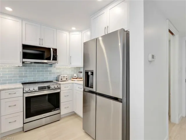 Fully stocked kitchen featuring, Quartz Countertops, brand new cabinetry, brand new appliances, under mount lighting
