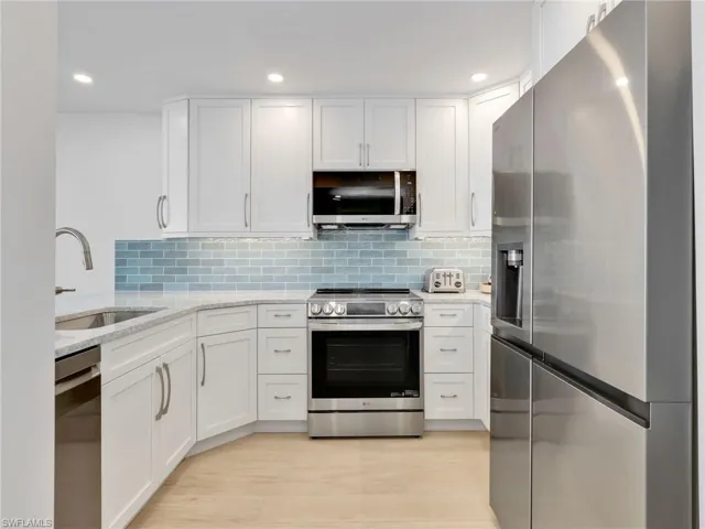 Fully stocked kitchen featuring, Quartz Countertops, brand new cabinetry, brand new appliances, under mount lighting