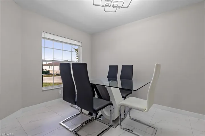 Dining area with marble finish floors and baseboards