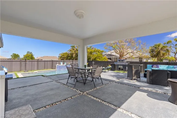 View of patio with an outdoor hangout area, a fenced backyard, and outdoor dining space