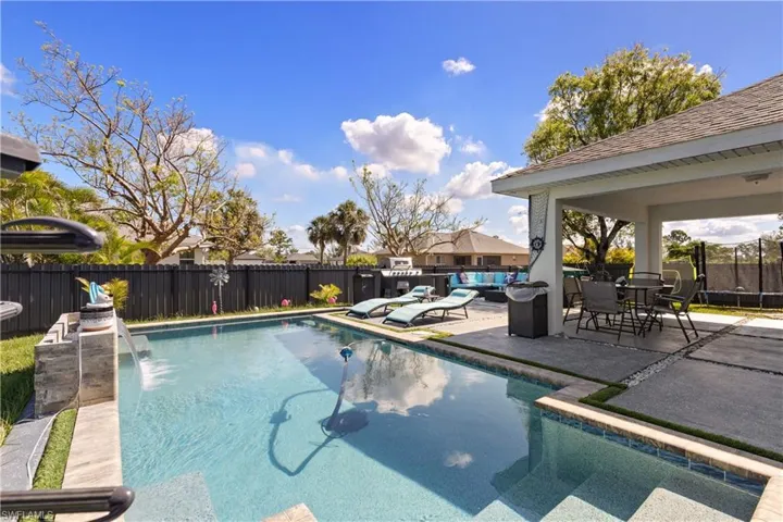 View of swimming pool with a patio area, a fenced backyard, and outdoor lounge area