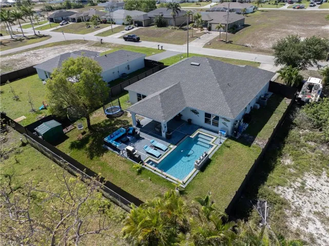 Aerial perspective of suburban area with a pool area