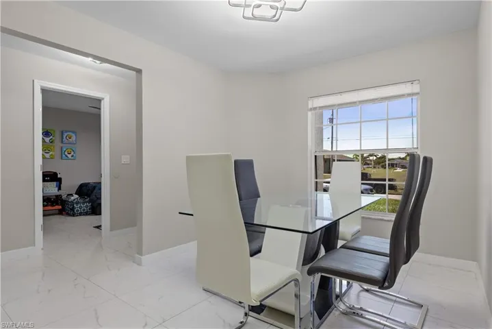 Dining area featuring light marble finish flooring and baseboards