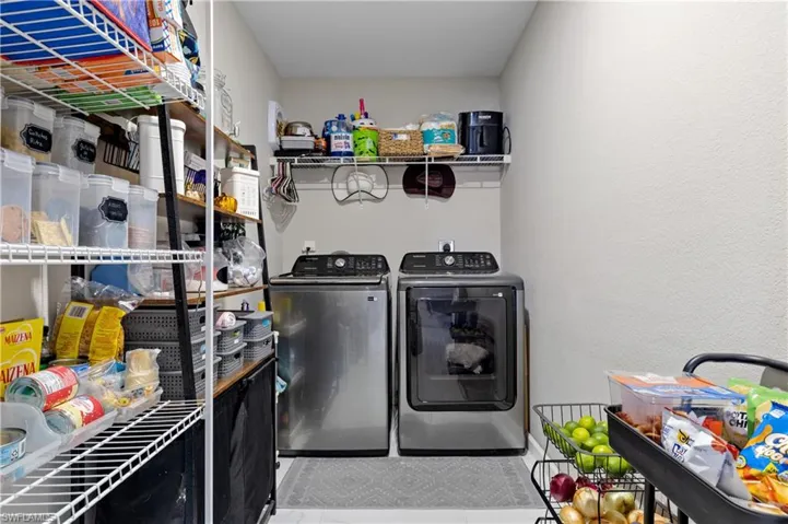 Laundry area with washing machine and dryer and baseboards
