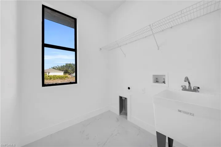 Laundry area featuring electric dryer hookup, marble finish floors, and hookup for a washing machine