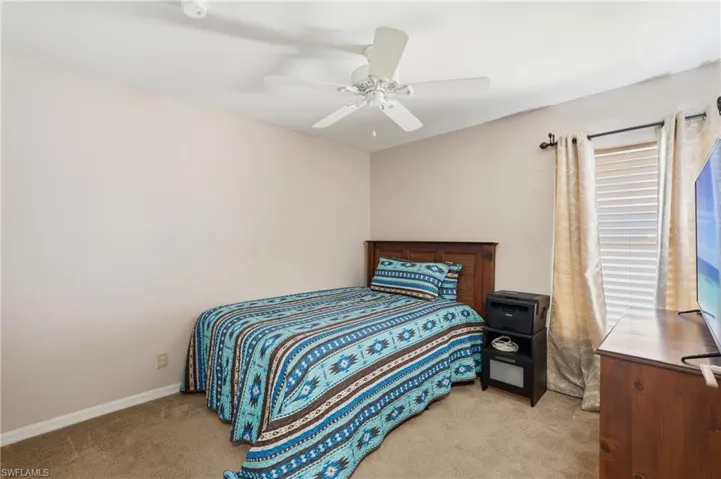Neutral tone walls complement the textured carpet flooring