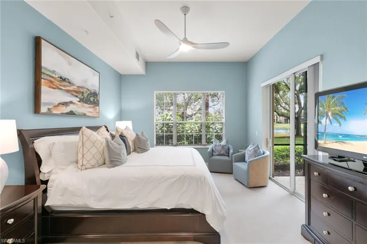 Bedroom with access to exterior, a ceiling fan, and carpet