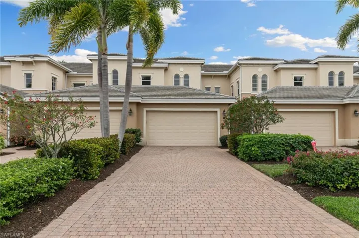 Mediterranean / spanish home with stucco siding, a garage, and decorative driveway