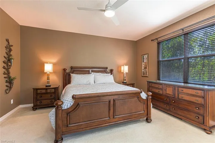 Bedroom featuring light carpet and a ceiling fan