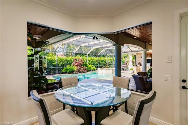 Dining space featuring wooden ceiling, ceiling fan, and crown molding