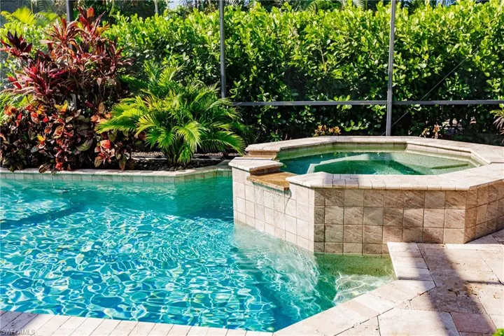 View of pool with an in ground hot tub