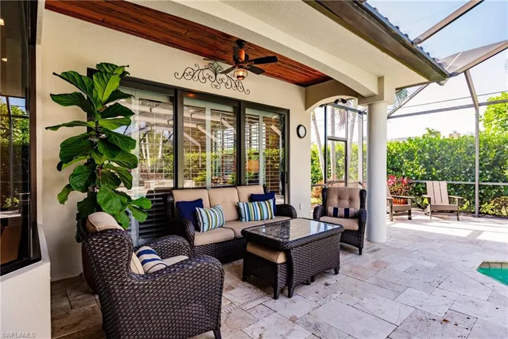 View of patio with an outdoor living space and ceiling fan