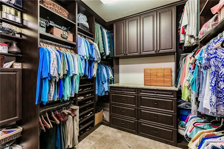 Spacious closet with light tile flooring