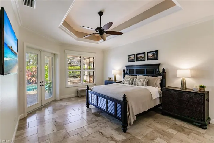 Bedroom featuring tile floors, french doors, ceiling fan, and access to exterior