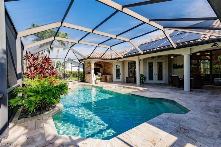 View of pool featuring ceiling fan, french doors, glass enclosure, and a patio
