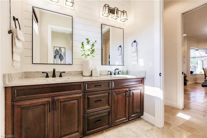 Bathroom with dual vanity and tile flooring