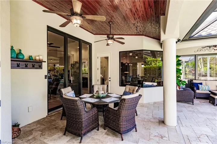 View of patio with outdoor lounge area and ceiling fan