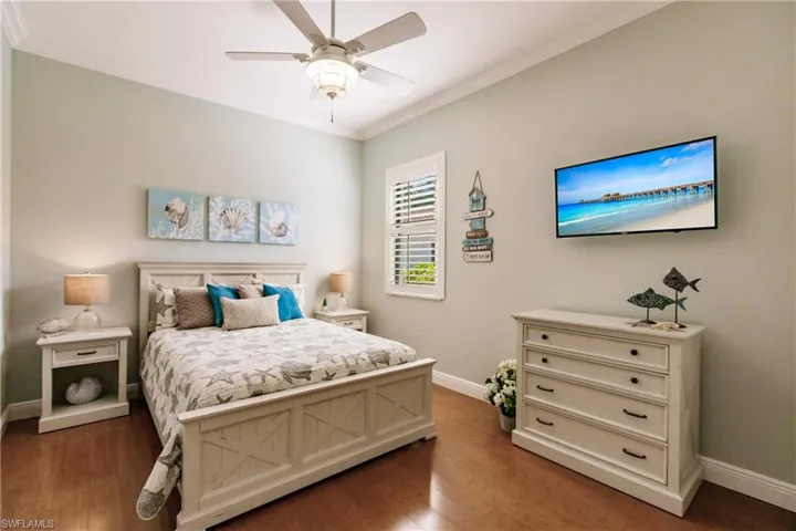 Bedroom featuring ornamental molding, ceiling fan, and dark hardwood / wood-style floors