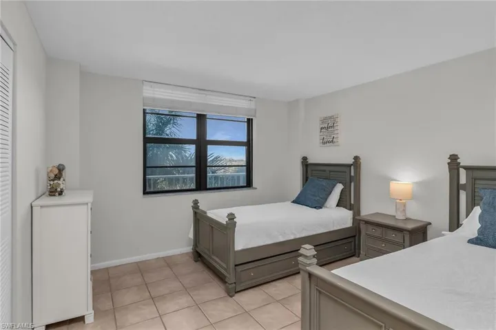 Bedroom with light tile patterned floors and baseboards