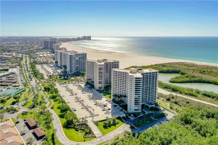 Drone / aerial view with a water view and a view of the beach