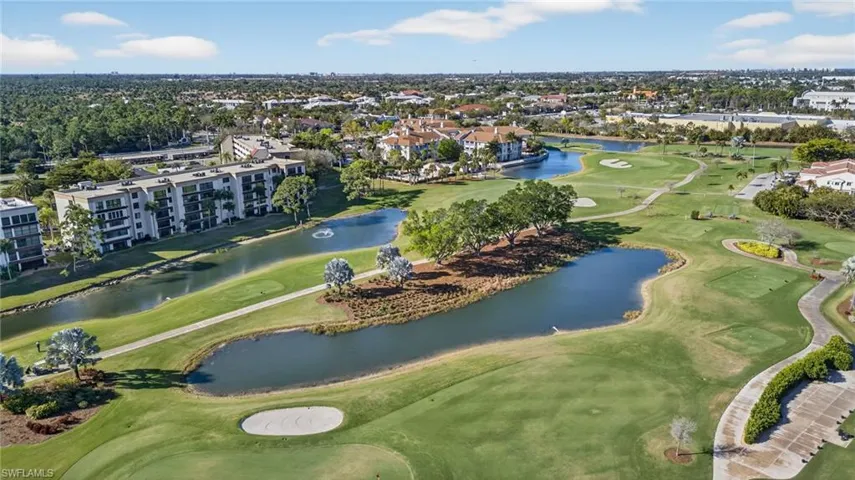 Drone / aerial view of a local golf course and a nearby body of water