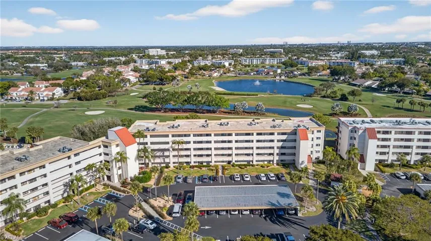 Drone / aerial view of a local golf course and a nearby body of water