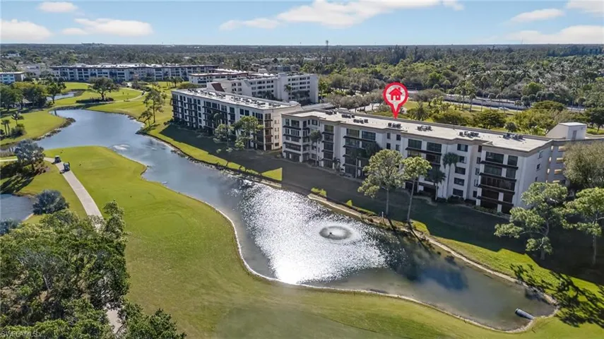 Bird's eye view of apartment complex and a nearby body of water