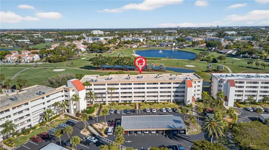 Drone / aerial view of a golf course and a large body of water