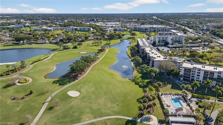 View of property location with a large body of water and a local golf course
