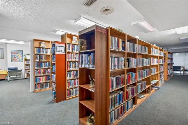 Misc room with a textured ceiling and bookshelves