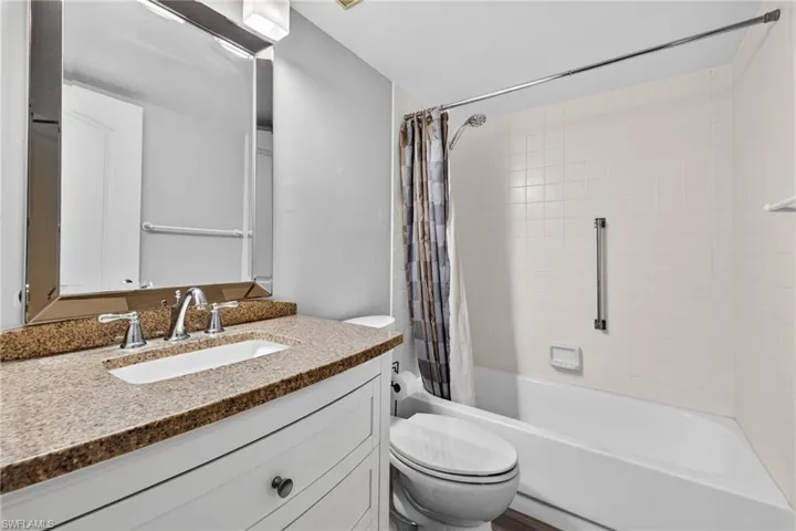 Bathroom with vanity and shower / tub combo