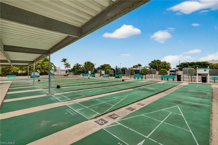 View of property's community featuring shuffleboard