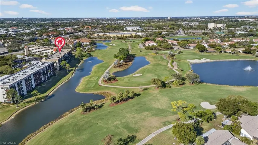 View of property location featuring a golf course and a nearby body of water