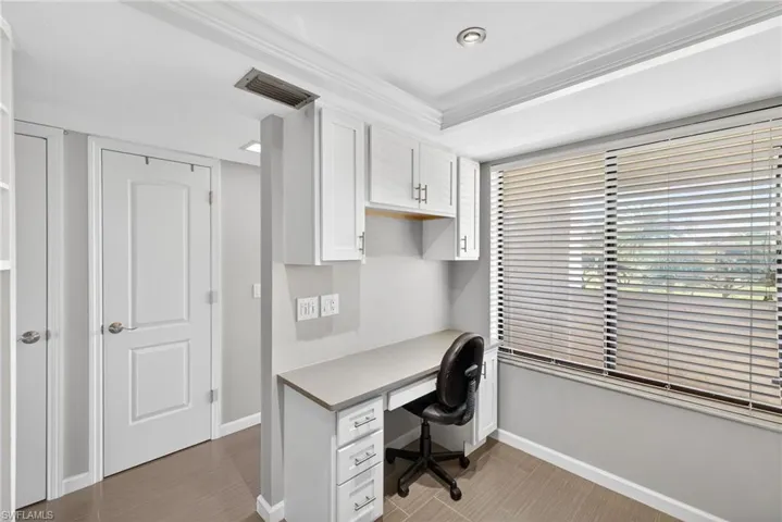 Office area featuring baseboards and crown molding