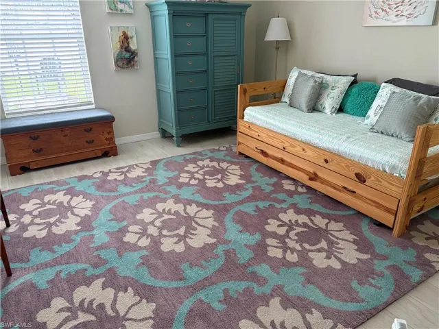 Sitting room with light wood-style flooring and baseboards